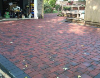 Backyard with brick flooring installed by pavers