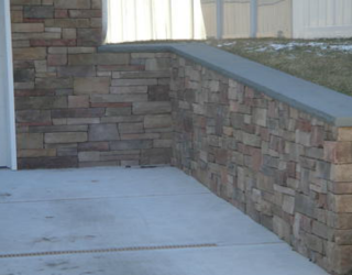 stone wall lined driveway installed by pavers